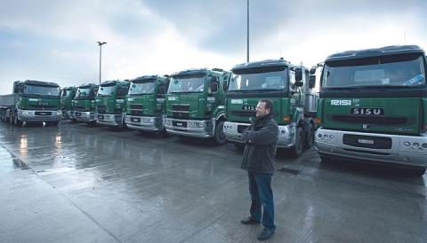 man in front of the fleet of trucks