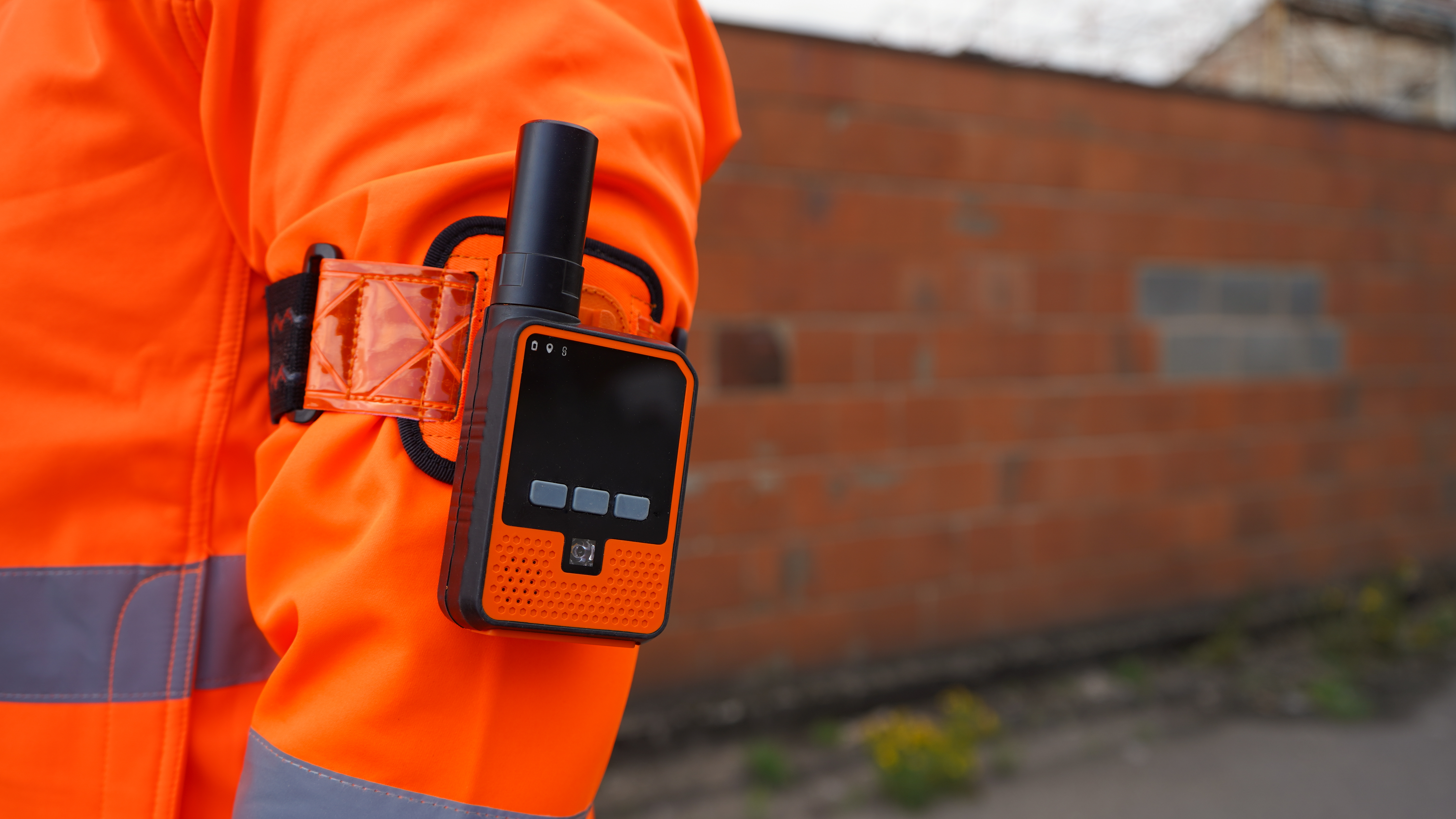 A close-up of Tended's geofencing wearable device attached to a railway worker's sleeve 