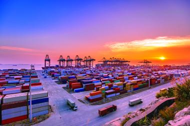 Shipping containers at a commercial port representing GNSS asset tracking for logistics and cargo monitoring