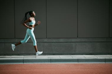 Runner wearing a smartwatch, illustrating GNSS wearable technology for fitness tracking