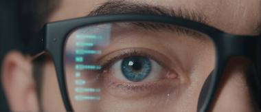 Close-up of a person wearing smart glasses, illustrating wearable technology and augmented reality applications
