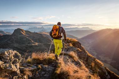 Hiker on a mountain ridge, illustrating GNSS positioning in remote terrain