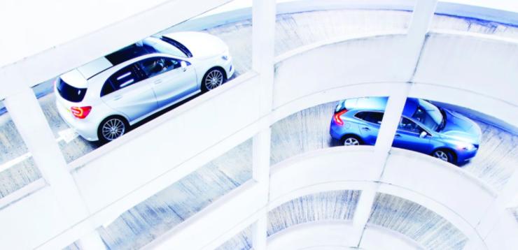 Two cars driving into a garage