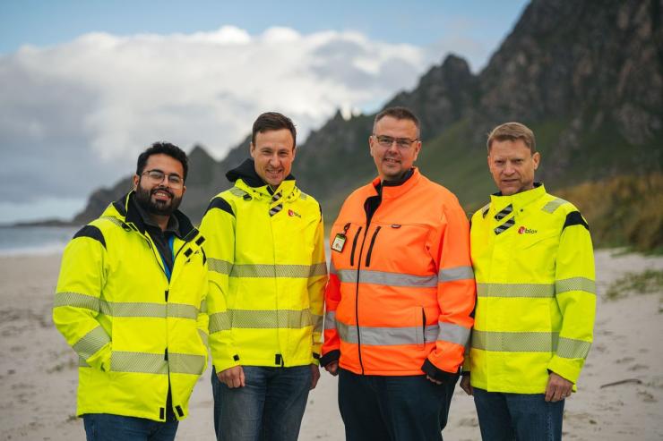 jammertest-2025-team-on-andøya-beach-testing-gnss-resilience.jpeg Four u-blox engineers in high-visibility jackets stand on the beach at Andøya, Norway during Jammertest 2025. Mountains and ocean are visible in the background as the team prepares to validate GNSS receiver resilience against jamming and spoofing interference. This image highlights the real-world environment and collaborative spirit of the live-field testing event, central to the Jammertest 2025 story.