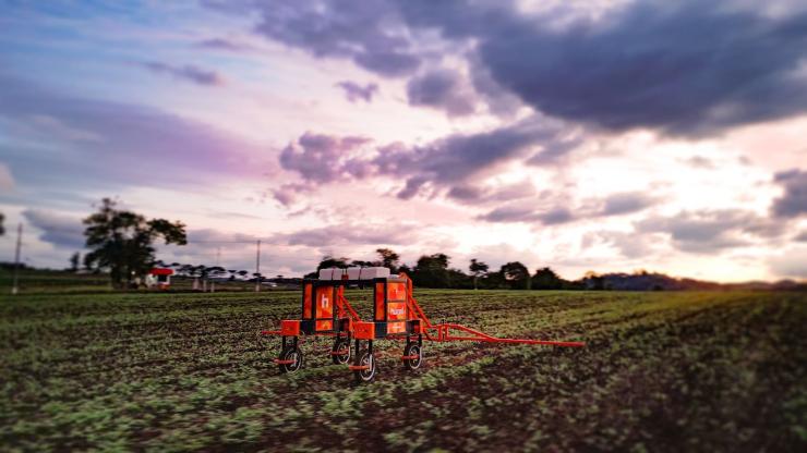 A Hural agricultural robot operates autonomously in a cultivated field at sunset. The robotic agriculture solution supports precision farming workflows that can benefit from accurate GNSS positioning and navigation technologies.