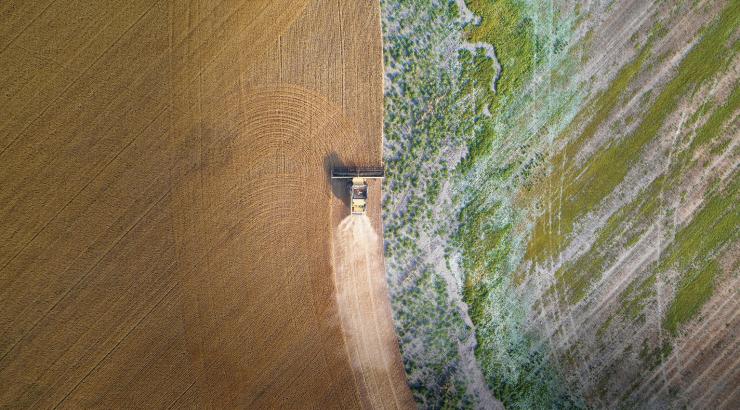 an aerial view of a tractor in a field