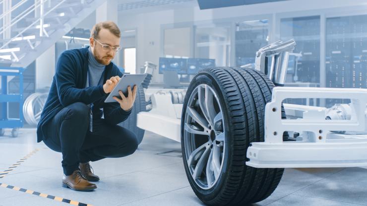 An engineer checking the chassis settings in the futuristic laboratory