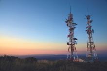 two communication towers standing in the remote area