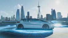 Two people enjoying the ride in autonomous car through futuristic city