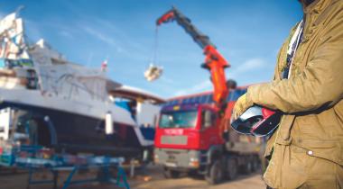 Construction worker at work site with crane