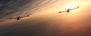 Two military UAS drones flying at sunset representing GNSS-dependent navigation in contested environments