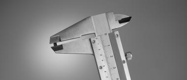A precision caliper measuring the compact size of a u-blox GNSS chip, highlighting its small form factor for space-constrained designs