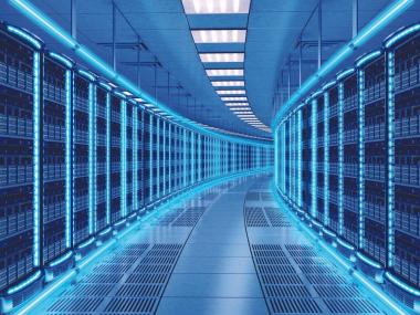 Rows of illuminated server racks inside a data center facility with network and computing infrastructure