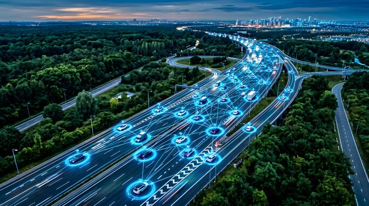 Aerial view of connected vehicles on a multi-lane highway at night, illustrating safe GNSS positioning for ADAS and automated driving